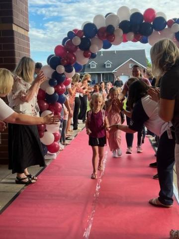 students walking the red carpet