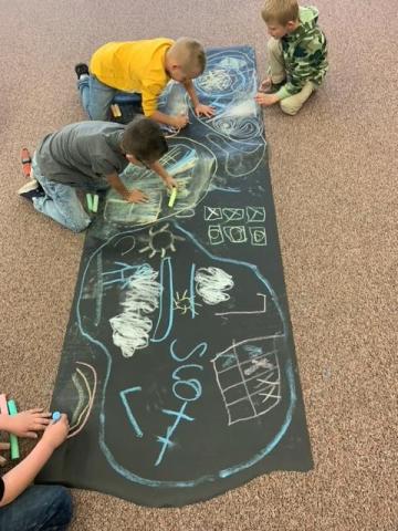 students getting creative with chalk.