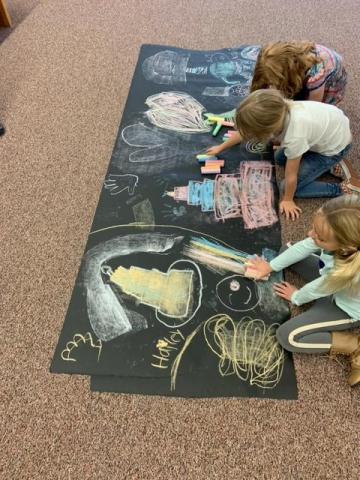 more student's coloring with chalk
