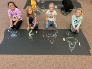 students using their imagination with chalk