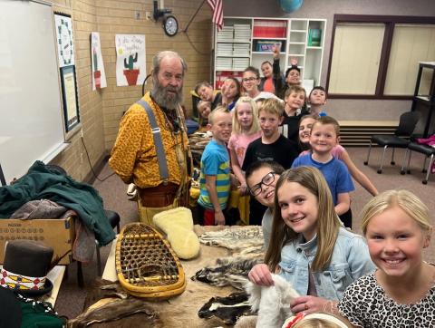 mountain man showing students his collection