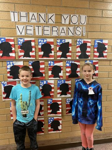4th graders in front of their veterans day art