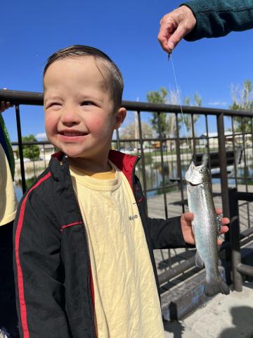 Boy holding a fish he caught