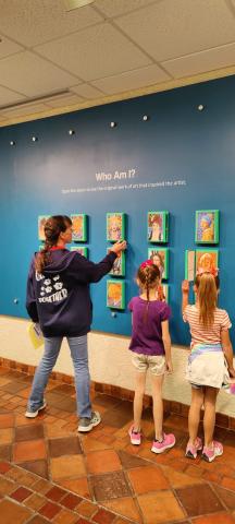 Mrs. Nelson and students looking at art