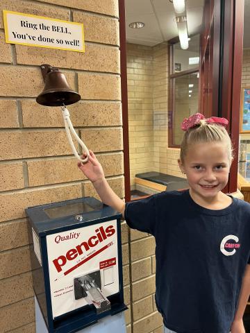 student ringing a bell