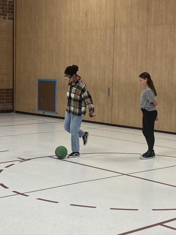 Student kicking a ball
