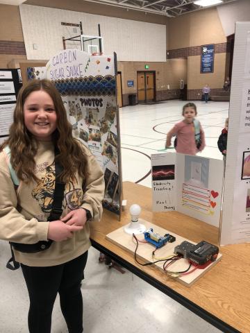 student showing science project