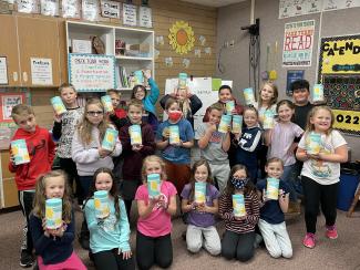 Third graders posing with the donated wipes.